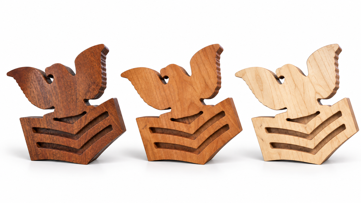 Blank PO1 rank mallet heads on a white background: sapele, cherry, and maple from left to right